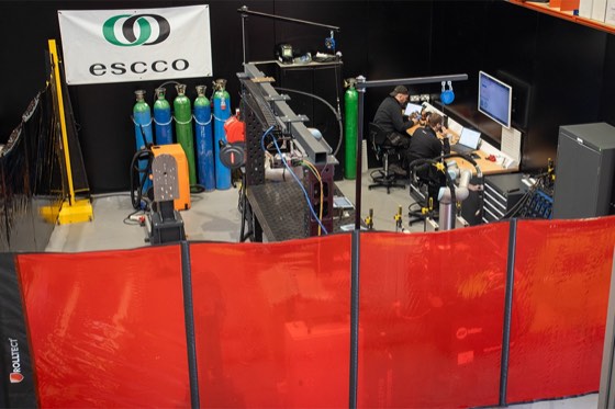 Close view of the cobot arm and welding torch in the demonstration area